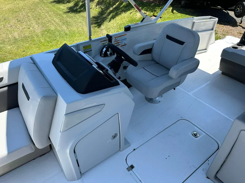 Slide: The Image of 2024 Hurricane FunDeck 2260 RE OB boat interior with captain's chair and control console. - 9