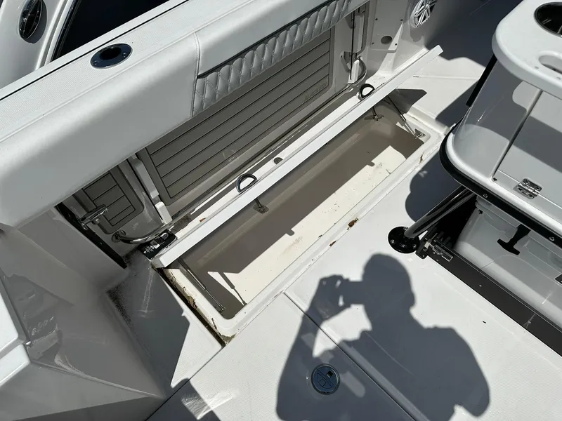 Slide: The Image of 2024 Blackfin 252 CC open storage compartment on deck. - 17
