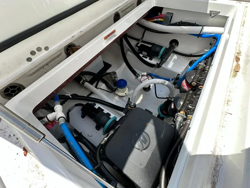 Slide: The Image of 2024 Blackfin 252 CC boat engine compartment with wiring and components. - 18
