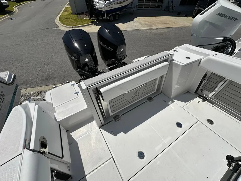 Slide: The Image of 2024 Blackfin 252 CC boat with dual Mercury outboard engines, rear deck view. - 19