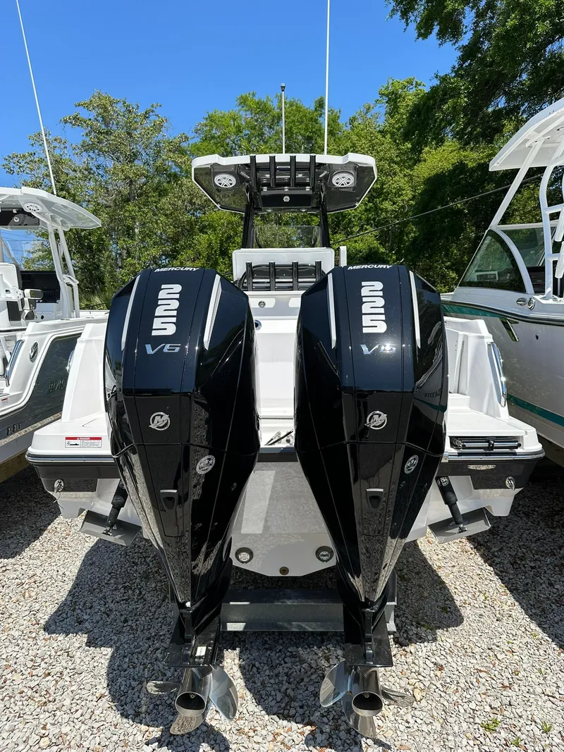 Slide: The Image of 2024 Blackfin 252 CC boat with twin V6 outboard engines, rear view. - 2
