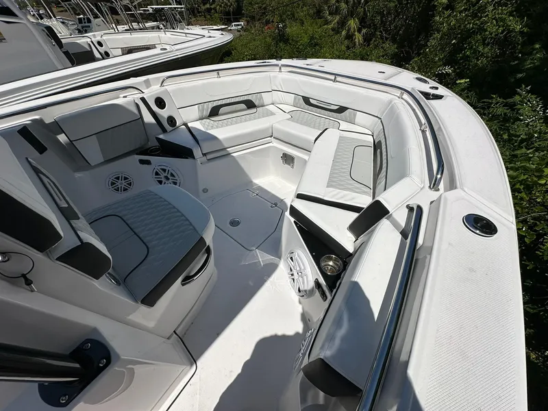 Slide: The Image of 2024 Blackfin 252 CC boat interior with cushioned seating and speakers. - 4