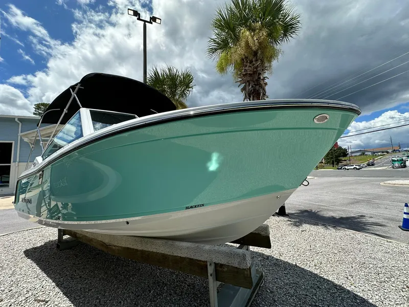 Slide: The Image of 2024 Blackfin 232 DC boat on trailer at marine center, side view. - 1