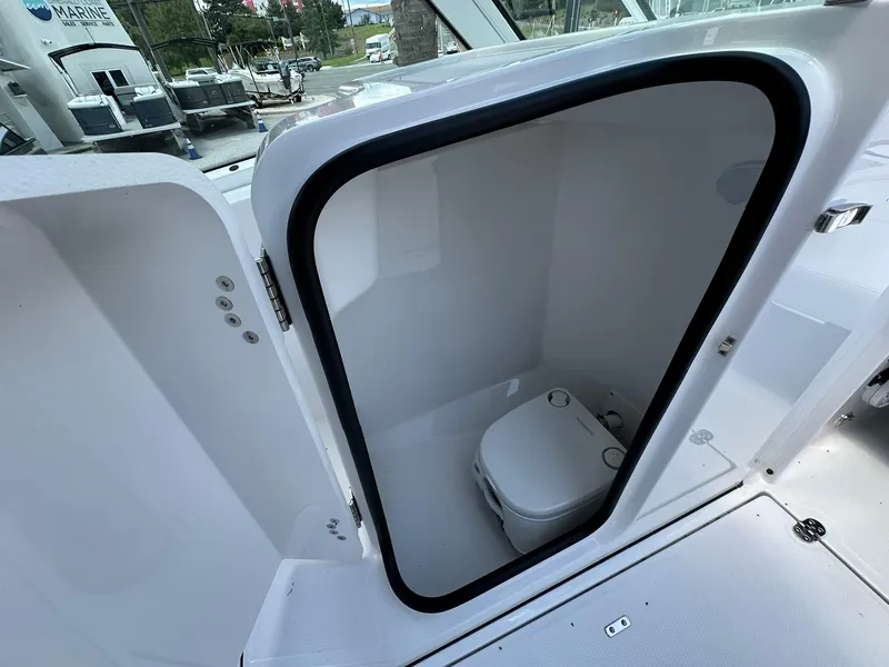 Slide: The Image of 2024 Blackfin 232 DC boat interior with compact marine toilet. - 10