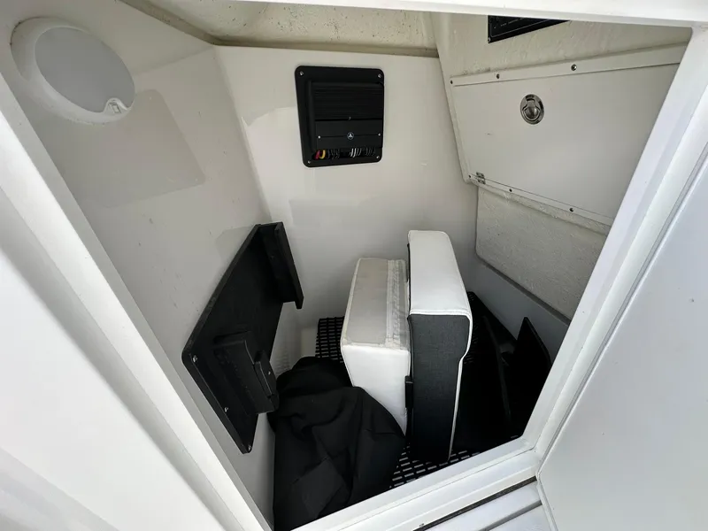 Slide: The Image of 2024 Blackfin 232 DC interior storage compartment with seating and equipment. - 11