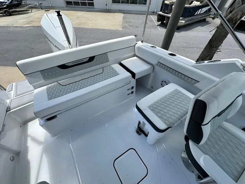 Slide: The Image of 2024 Blackfin 232 DC boat interior with white seating and modern design. - 13