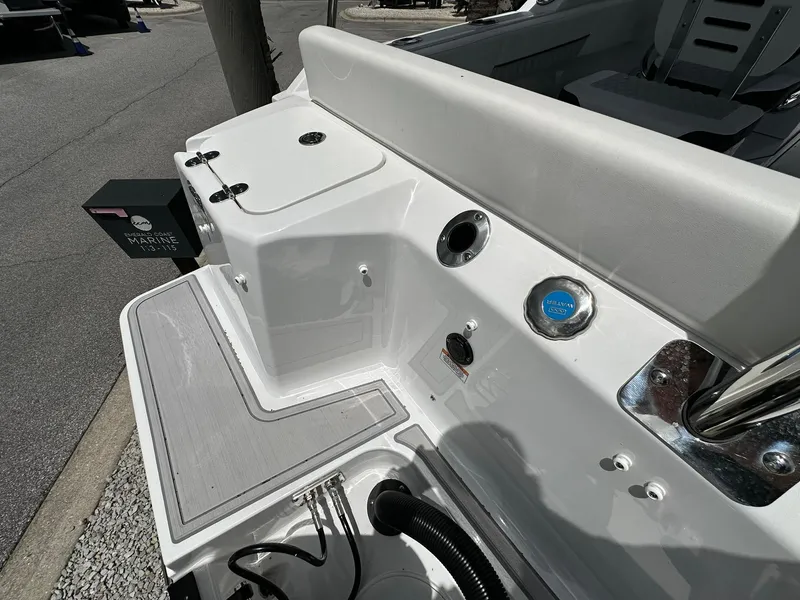 Slide: The Image of 2024 Blackfin 232 DC boat deck with seating and storage compartments. - 14
