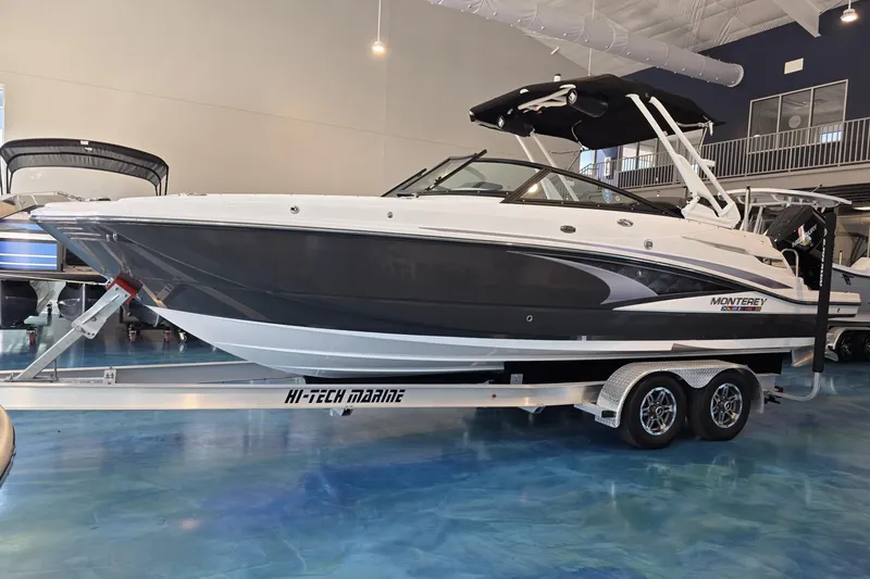 Slide: The Image of 2024 Monterey M-65 boat on trailer in showroom, featuring sleek design and modern features. - 1