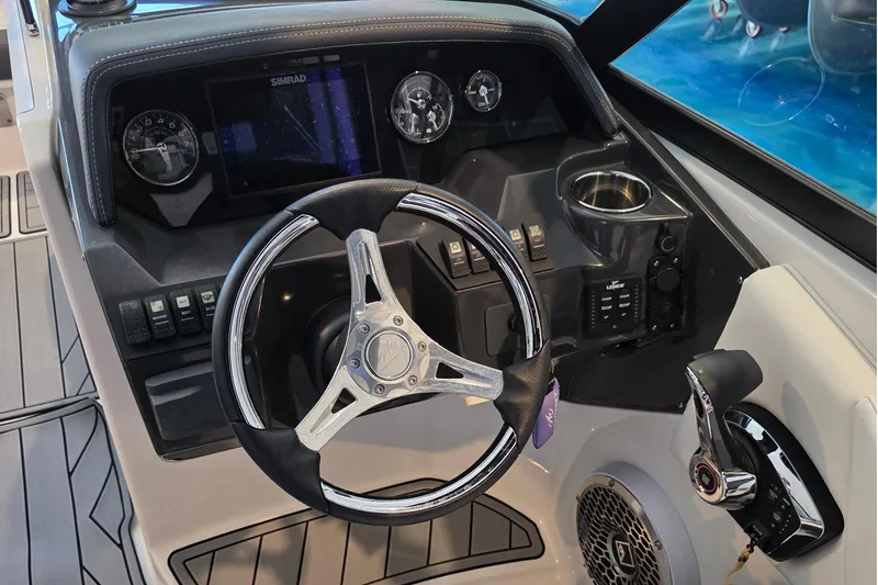 Slide: The Image of 2024 Monterey M-65 boat dashboard with steering wheel and control panel. - 12