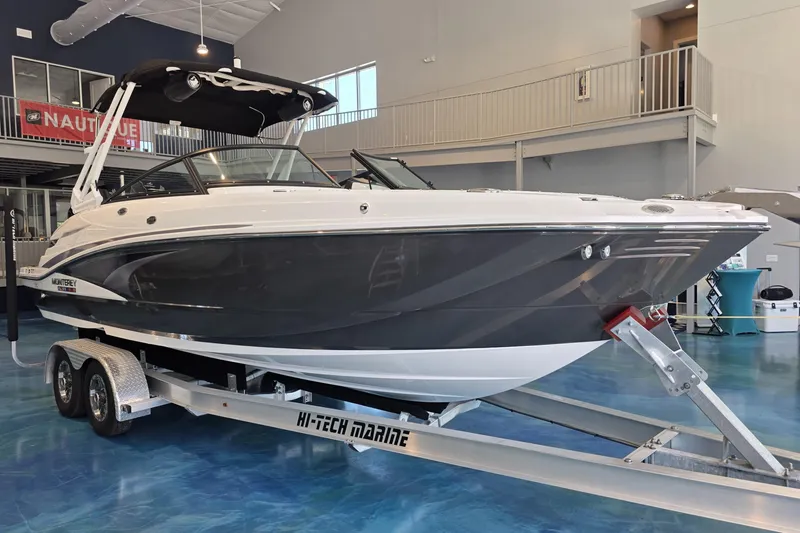 Slide: The Image of 2024 Monterey M-65 boat on trailer in showroom, featuring sleek design and modern amenities. - 3