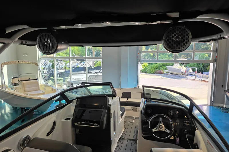 Slide: The Image of 2024 Monterey M-65 boat interior with modern dashboard and spacious seating in showroom. - 8