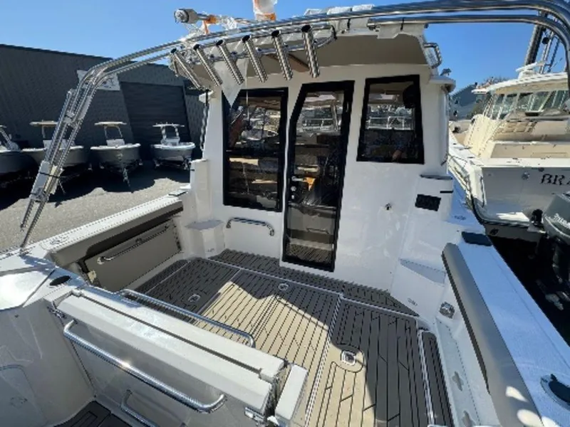 Slide: The Image of 2024 Cutwater C-288 C LE boat deck with glass doors and fishing rod holders. - 2