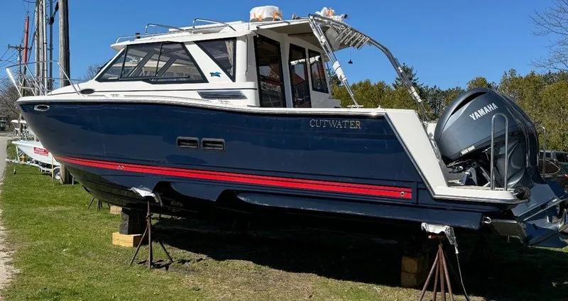 Slide: The Image of 2024 Cutwater C-288 C LE boat on land with Yamaha outboard motor. - 3