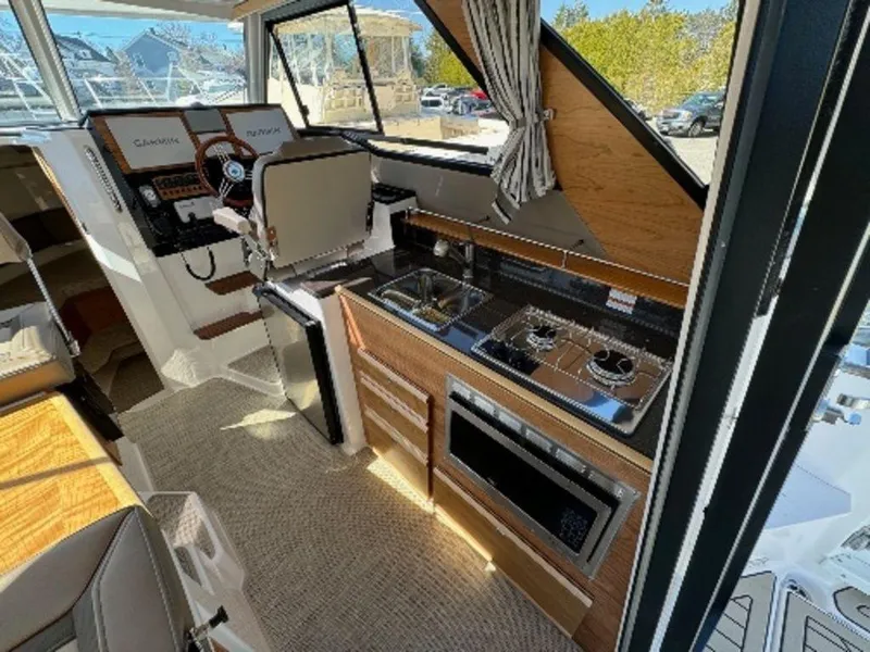Slide: The Image of 2024 Cutwater C-288 C LE boat interior with kitchen and helm station. - 5