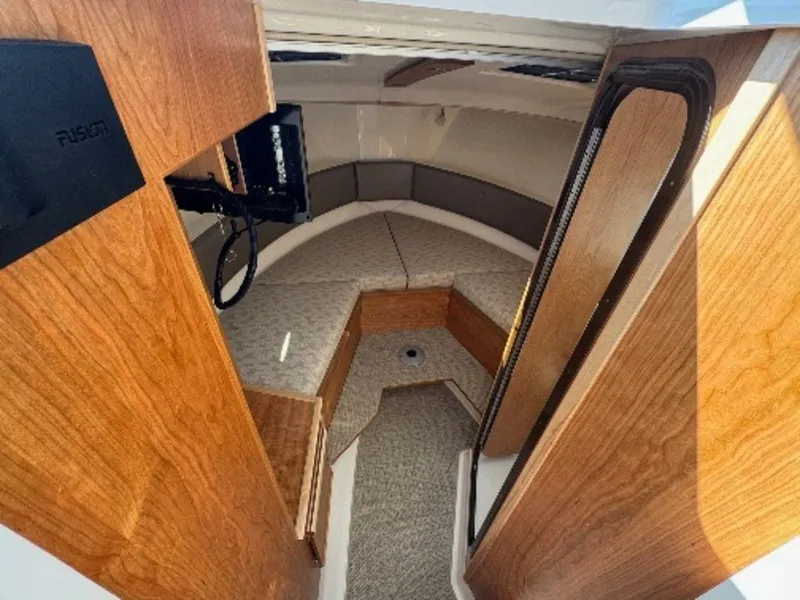 Slide: The Image of 2024 Cutwater C-288 C LE cabin interior with wood finish and cushioned seating. - 7
