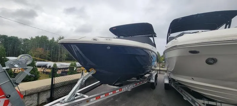 Slide: The Image of 2024 Sea Ray SLX 260 boat on trailer, displayed outdoors. - 0