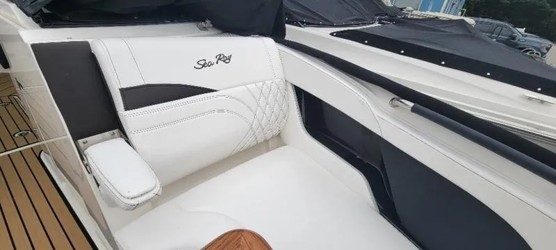Slide: The Image of 2024 Sea Ray SLX 260 boat interior with white leather seating and elegant design. - 12