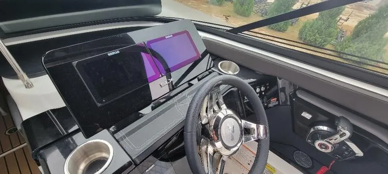 Slide: The Image of 2024 Sea Ray SLX 260 helm with modern controls and dual displays. - 22