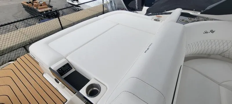 Slide: The Image of 2024 Sea Ray SLX 260 boat with spacious white seating and cup holder. - 24
