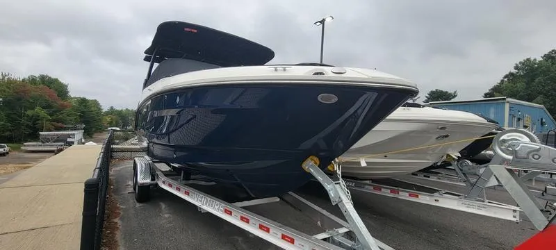 Slide: The Image of 2024 Sea Ray SLX 260 boat on trailer, sleek design, parked outdoors. - 26