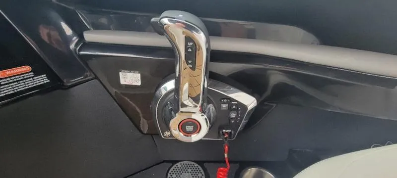 Slide: The Image of 2024 Sea Ray SLX 260 throttle control in sleek black interior. - 29