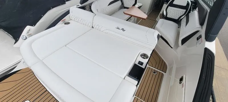 Slide: The Image of Luxurious 2024 Sea Ray SLX 260 boat interior with white seating and wood accents. - 3