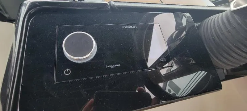 Slide: The Image of Fusion audio control panel on 2024 Sea Ray SLX 260 boat dashboard. - 30