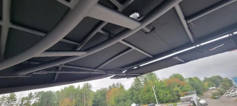 Slide: The Image of 2024 Sea Ray SLX 260 boat canopy with scenic forest background. - 6