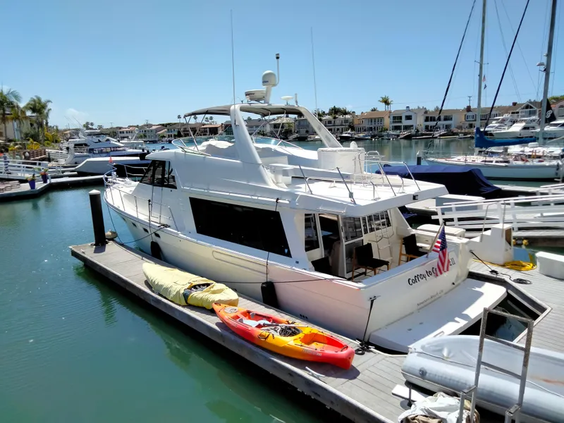 The Image of 1998 Bayliner 4788 Motoryacht docked with kayaks. - 1