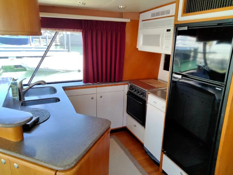 Slide: The Image of 1998 Bayliner 4788 yacht kitchen with modern appliances. - 10