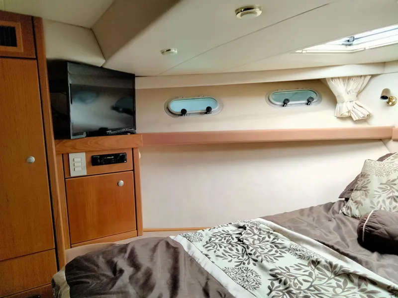 Slide: The Image of Interior of 1998 Bayliner 4788 yacht with bed and TV. - 15