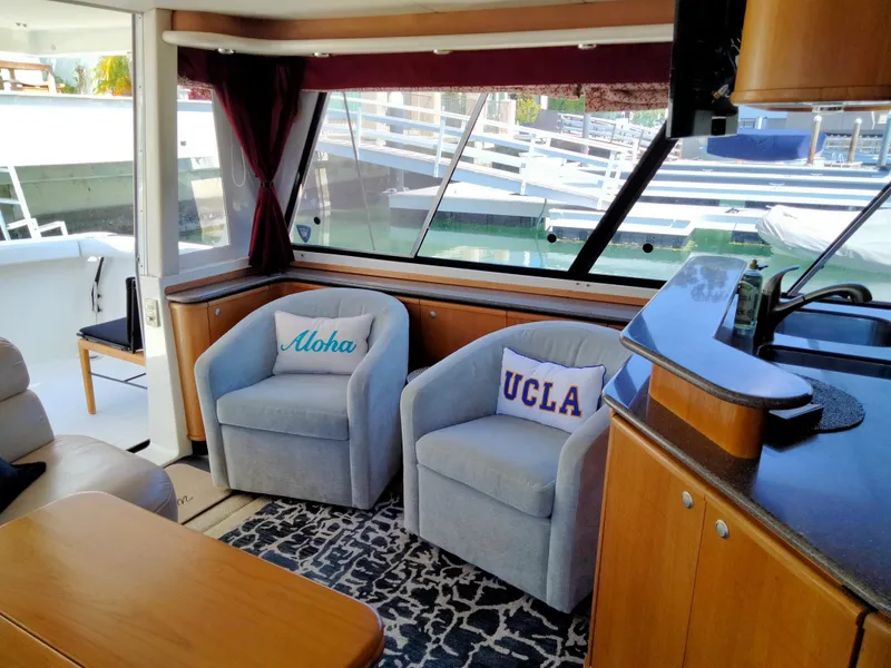 Slide: The Image of Interior of 1998 Bayliner 4788 yacht with cozy chairs and decorative pillows. - 17