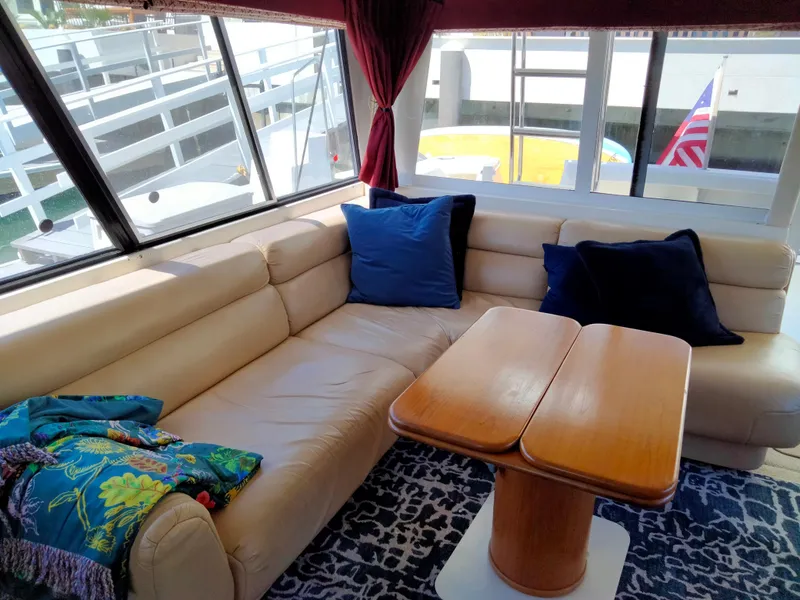 Slide: The Image of Interior of 1998 Bayliner 4788 yacht with leather sofa and wooden table. - 19