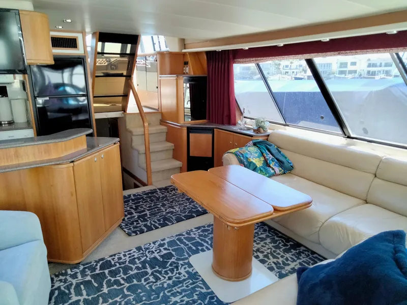 Slide: The Image of Interior of a 1998 Bayliner 4788 yacht with sofa and table. - 20