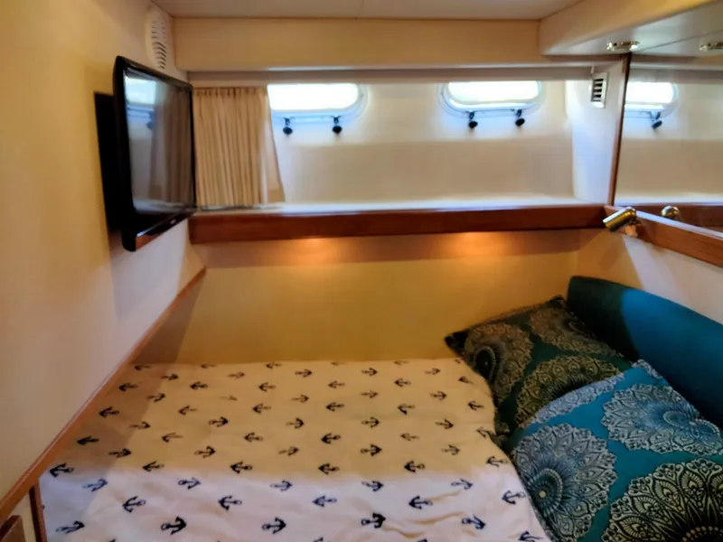 Slide: The Image of Interior of Bayliner 4788 yacht featuring cozy bedroom. - 22