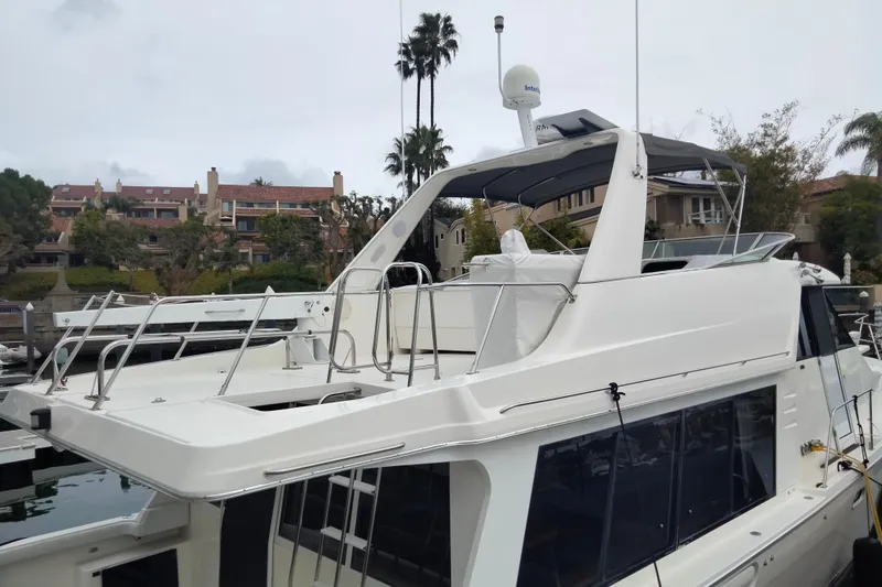 Slide: The Image of 1998 Bayliner 4788 Pilot House Motoryacht docked near residential area. - 27