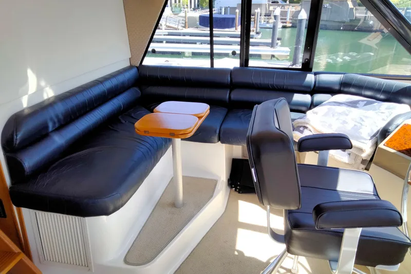 Slide: The Image of Luxurious interior of 1998 Bayliner 4788 Pilot House Motoryacht with leather seating and table. - 28