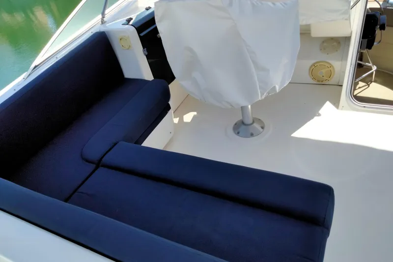 Slide: The Image of 1998 Bayliner 4788 Pilot House Motoryacht interior with blue seating and covered helm. - 29