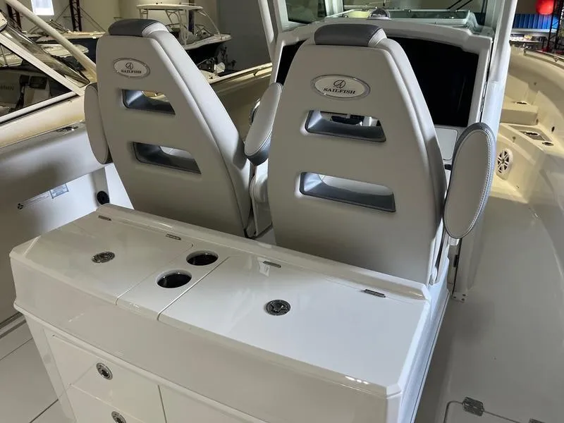 Slide: The Image of 2025 Sailfish 312 CC boat interior with dual seats and storage console. - 10