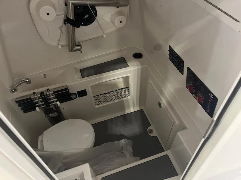 Slide: The Image of 2025 Sailfish 312 CC boat interior with compact bathroom amenities. - 16