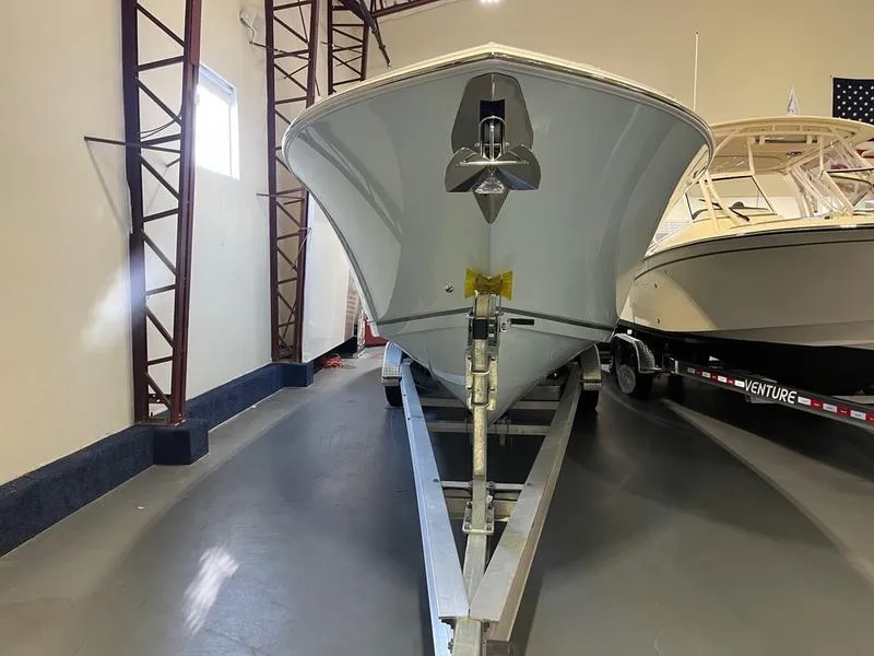 Slide: The Image of 2025 Sailfish 312 CC boat on trailer in indoor storage facility. - 3