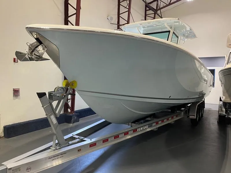 Slide: The Image of 2025 Sailfish 312 CC boat on trailer in indoor showroom. - 4
