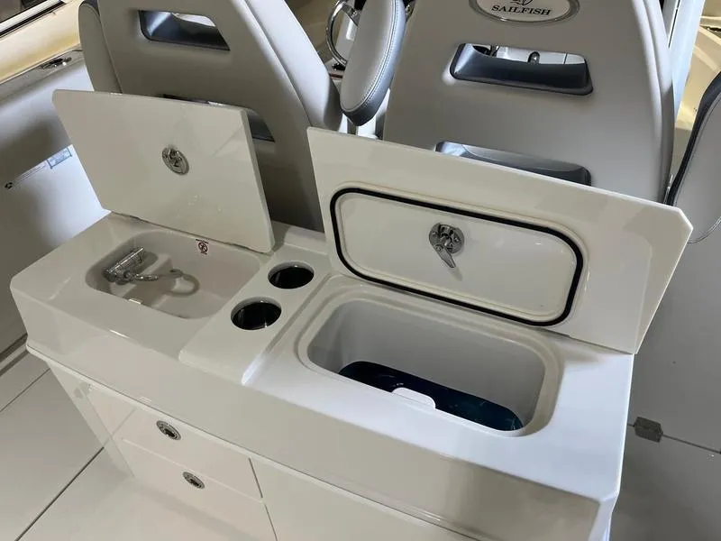 Slide: The Image of 2025 Sailfish 312 CC boat interior with storage compartments and cup holders. - 9