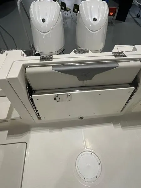 Slide: The Image of 2025 Sailfish 276 DC boat with dual outboard engines and storage compartment. - 10