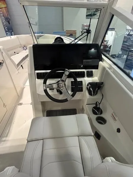 Slide: The Image of 2025 Sailfish 276 DC boat cockpit with steering wheel and control panel. - 11