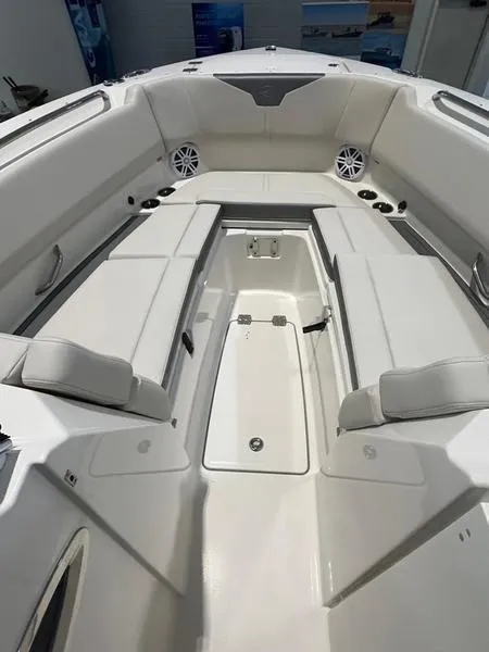 Slide: The Image of 2025 Sailfish 276 DC boat interior with white seating and storage compartments. - 6