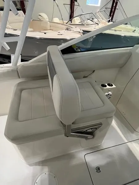 Slide: The Image of 2025 Sailfish 276 DC boat interior with white cushioned seating. - 8