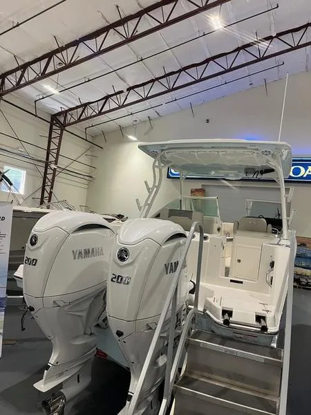 Slide: The Image of 2025 Sailfish 276 DC boat with twin Yamaha 200 engines in a showroom. - 9