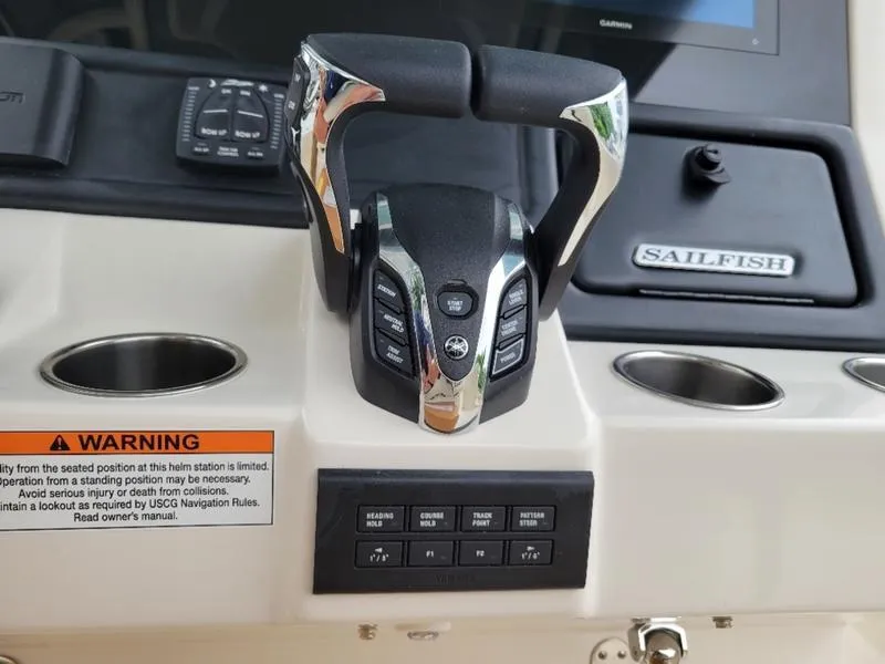 Slide: The Image of 2025 Sailfish 272 CC boat control panel with throttle and warning label. - 13
