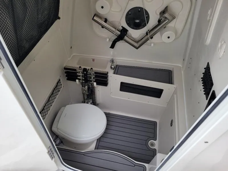 Slide: The Image of 2025 Sailfish 272 CC boat interior with toilet and storage compartments. - 28